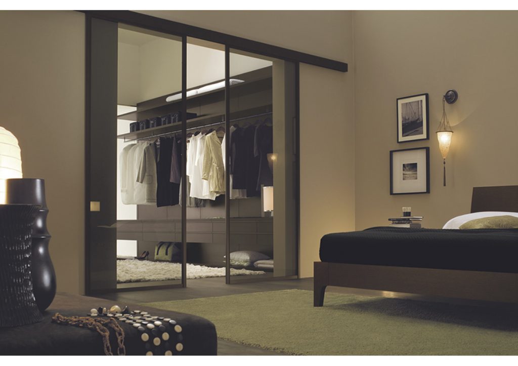 Bedroom furniture solutions: glass door walk in wardrobe